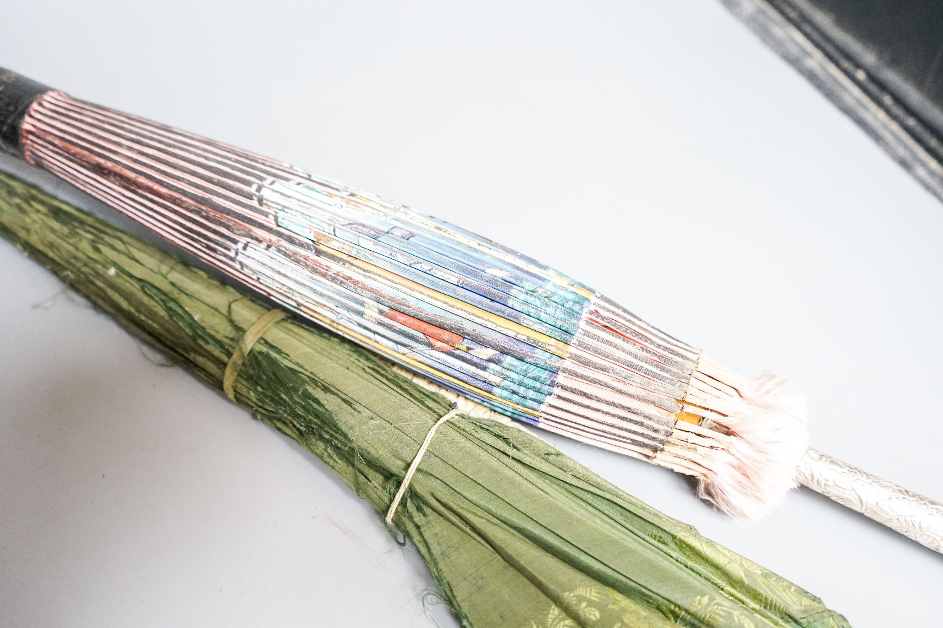 A 19th century Chinese Canton export ivory parasol with carved Ivory handle and a Burmese white metal handled painted fabric parasol